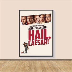 May include: A film poster for the movie "Hail, Caesar!" featuring a red title and a group of actors including George Clooney, Josh Brolin, Scarlett Johansson, and Channing Tatum. The poster also includes the text "Written and Directed by Joel & Ethan Coen".