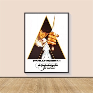 May include: A movie poster for Stanley Kubrick's "A Clockwork Orange" featuring a man in a bowler hat holding a knife, with a white triangle behind him.