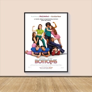May include: Movie poster for the film "Bottoms" featuring a group of young people in a variety of poses. The poster is set against a white background and features the title of the film in large, bold letters. The text "From the Producers of Pitch Perfect and Cocaine Bear" is also featured on the poster.