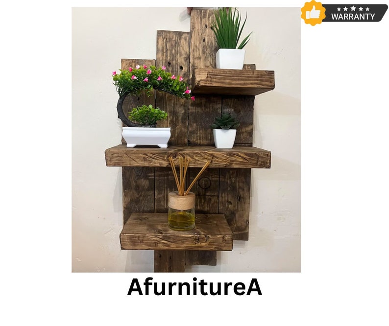 May include: A rustic, wooden wall shelf unit with three shelves. The shelves are made of reclaimed wood and hold small potted plants and a glass diffuser bottle. The text "AfurnitureA" is at the bottom.