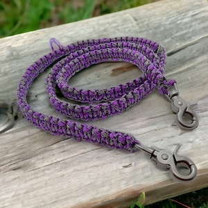May include: Purple and gray braided dog leash with two silver metal clips.