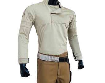 May include: A beige long-sleeved shirt with a brown belt and brown pants. The shirt has a high collar and a flap on the chest. The pants have cargo pockets and a thigh strap.