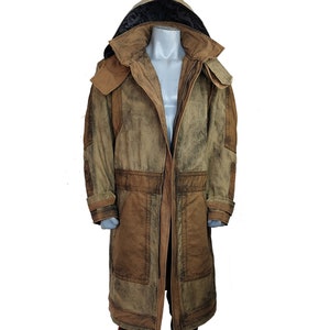 May include: A long, brown and green hooded jacket with a zipper closure and multiple pockets. The jacket has a distressed look and is made of a durable fabric.