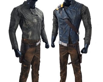 May include: Two mannequins wearing different outfits. The mannequin on the left is wearing a long-sleeved, dark green shirt with brown pants. The mannequin on the right is wearing a blue denim jacket with brown pants.
