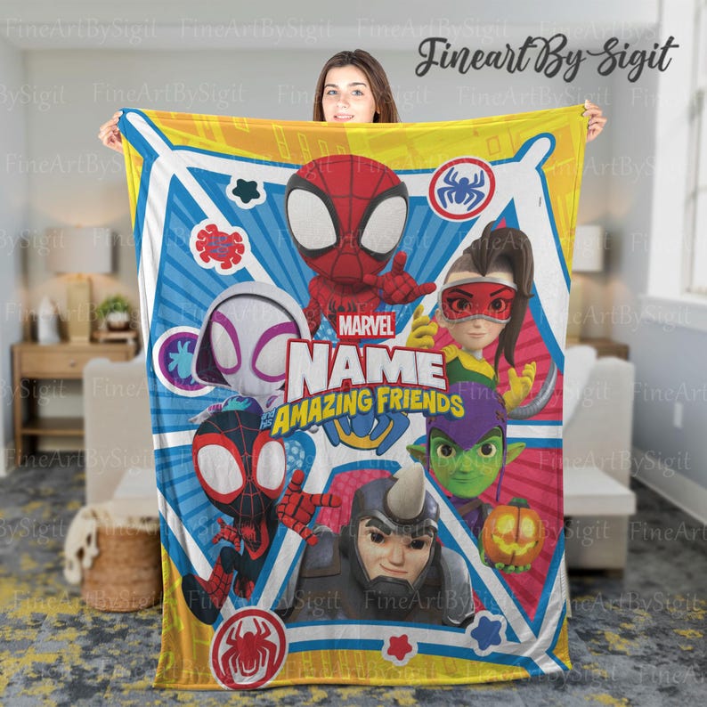 May include: A Marvel "Amazing Friends" blanket featuring cartoon characters including Spider-Man, Spider-Gwen, and others. The blanket has a white background with blue, yellow, and red accents. The text "Marvel Amazing Friends" is prominently displayed.