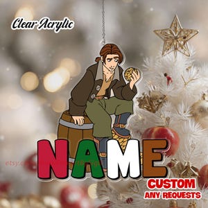 May include: Clear acrylic ornament featuring a cartoon character seated on a barrel, holding a golden sphere. The ornament has the word "NAME" in red, green, and brown letters. The text "Clear Acrylic" and "CUSTOM ANY REQUESTS" are also visible.