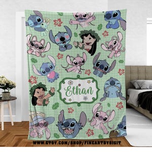 May include: A light green blanket featuring various cartoon characters in shades of blue and pink, along with a girl with a flower crown. The blanket has a grid pattern and includes the name "Ethan" in a decorative frame. The Etsy shop URL is visible at the bottom.