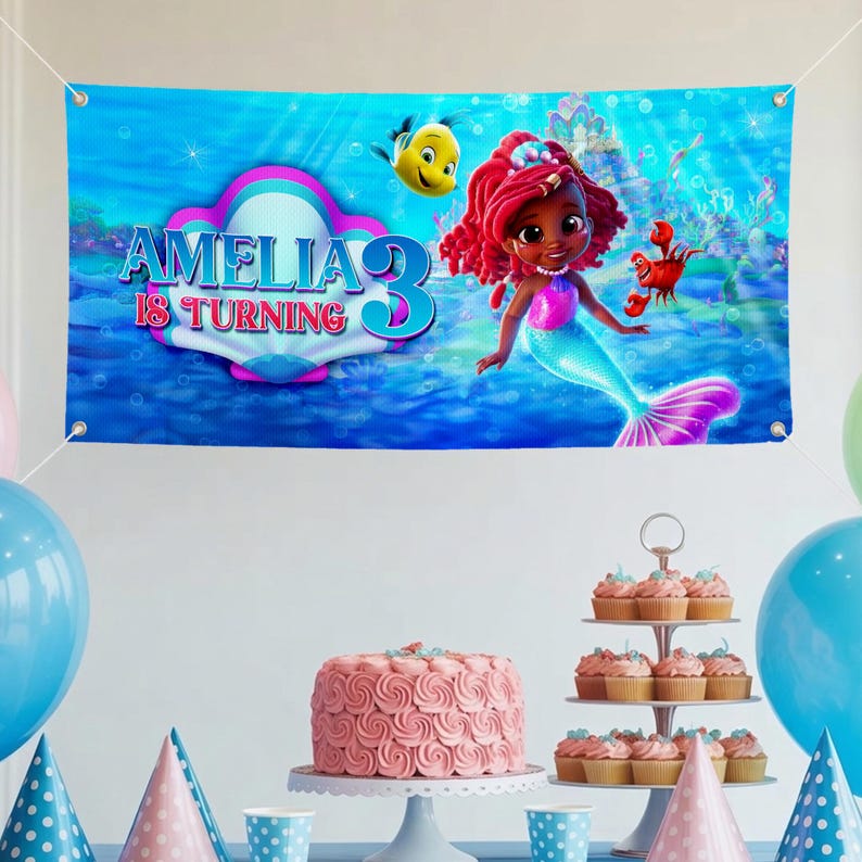 May include: A birthday party banner with the text "AMELIA IS TURNING 3" featuring a mermaid illustration. The banner is blue with a seashell design. A pink cake, cupcakes, and balloons decorate the party scene.