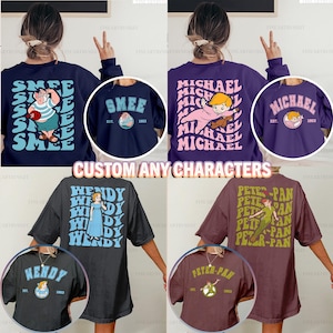 Puede incluir: Una colección de camisetas y sudaderas con personajes personalizados. Los diseños incluyen los personajes Smee, Michael, Wendy y Peter Pan. Cada diseño presenta el nombre del personaje y un gráfico.