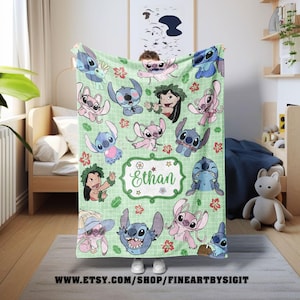 May include: A light green blanket featuring various cartoon characters in blue and pink. The blanket has a repeating pattern of the characters and red floral accents. A central frame displays the name "Ethan".