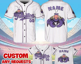 May include: White baseball jersey with purple stripes and a cartoon crab design. The jersey has the text "Fanatoa" and "00" on the front and "NAME" on the back.