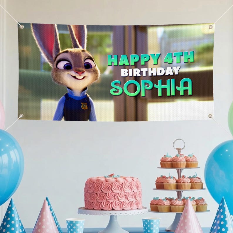 May include: A birthday banner featuring Judy Hopps from Zootropolis, with the text "HAPPY 4TH BIRTHDAY SOPHIA." A pink cake and cupcakes are on display. The banner is white with eyelets in each corner.