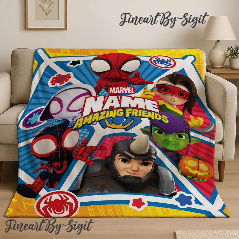 May include: A Marvel "Amazing Friends" blanket featuring various cartoon characters, including Spider-Man, Rhino, and others. The blanket has a colorful design with a yellow, blue, and red color scheme, and the Marvel logo is visible. The blanket is displayed on a beige couch.