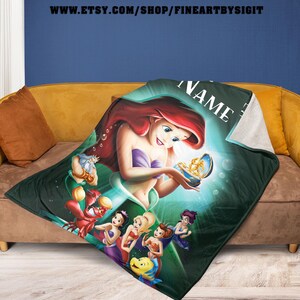 May include: A green and white blanket featuring Ariel from The Little Mermaid, holding a treasure. The blanket has a sherpa backing and features other characters from the movie. The Etsy shop URL is visible at the top.