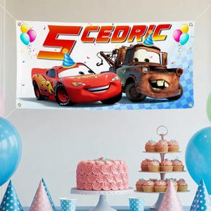 May include: A birthday banner featuring Lightning McQueen and Mater from the Cars movie, with the name "Cedric" and the number "5". The banner is decorated with balloons and confetti, perfect for a child's birthday party.