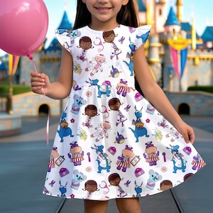 May include: A white dress with a pattern of cartoon characters, including a doctor, koala, and dragon. The dress has short sleeves and a flared skirt. A pink balloon is held in the left hand.