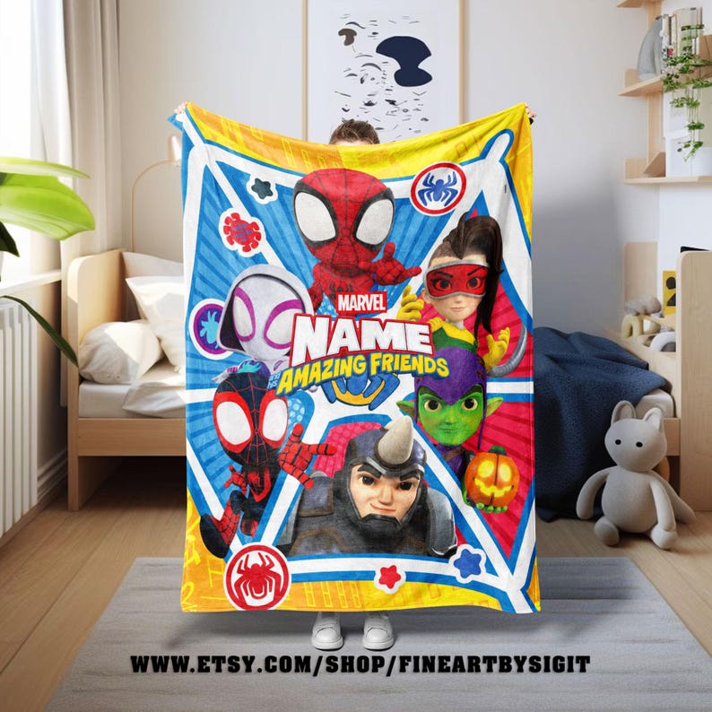 May include: A colorful Marvel "Amazing Friends" blanket featuring Spider-Man and other characters. The blanket has a blue background with yellow and white accents. The text "Marvel Name Amazing Friends" is prominently displayed.