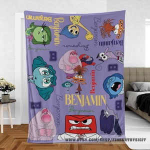 May include: A lavender blanket featuring cartoon characters from the movie "Inside Out". The blanket has the name "Benjamin" in yellow and white, along with various character illustrations in different colors.