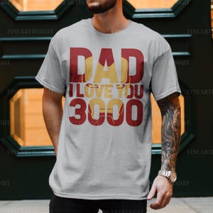 May include: A gray t-shirt with red text that reads "Dad I Love You 3000". The text is stylized to look like the Iron Man character from the Marvel movies.