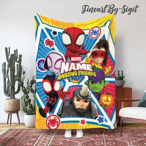 May include: A colorful Marvel "Amazing Friends" blanket featuring cartoon characters Spider-Man, Spider-Gwen, and others. The blanket has a yellow border and a blue and red background with the Marvel logo.
