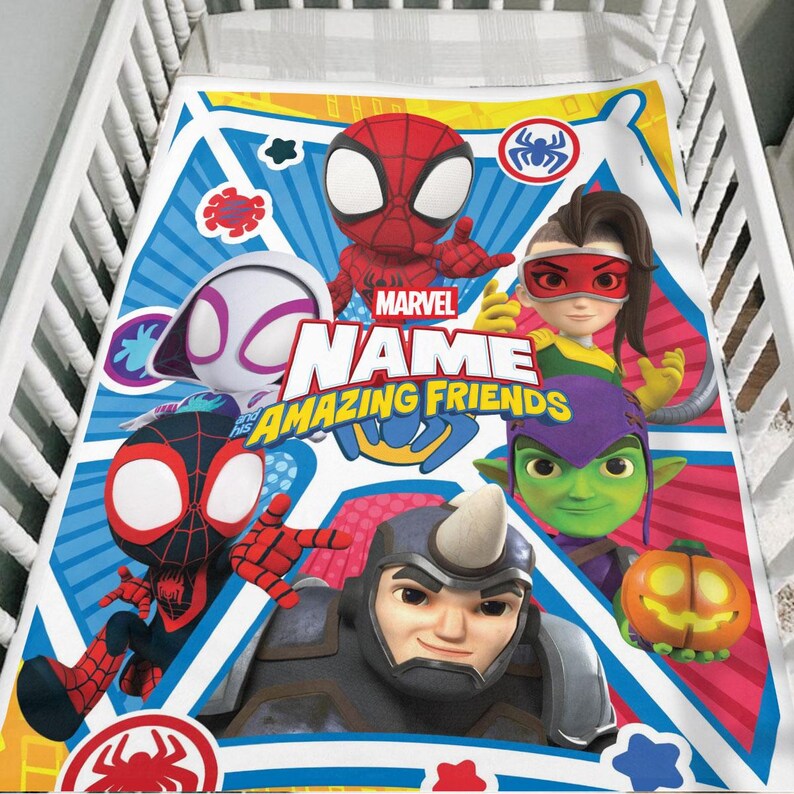 May include: A Marvel Amazing Friends baby blanket featuring Spider-Man, Spider-Gwen, Miles Morales, and other characters. The blanket has a blue, red, and white design with the text "Marvel Name Amazing Friends".