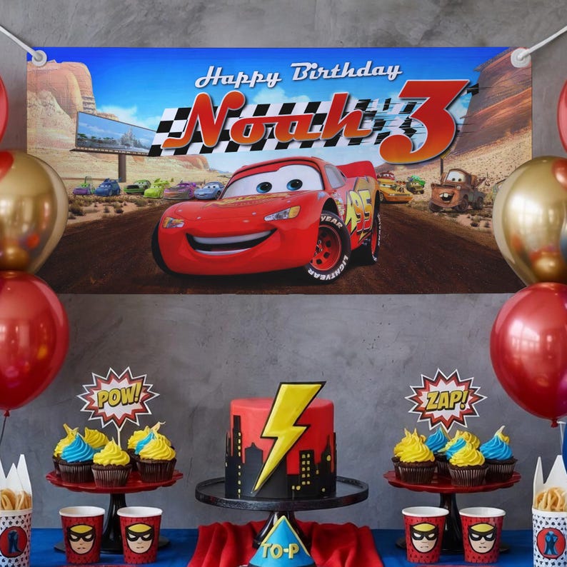 May include: A birthday party scene featuring a banner with Lightning McQueen from the movie Cars, balloons, cupcakes, and a cake with a lightning bolt design. The banner reads "Happy Birthday Noah 3".