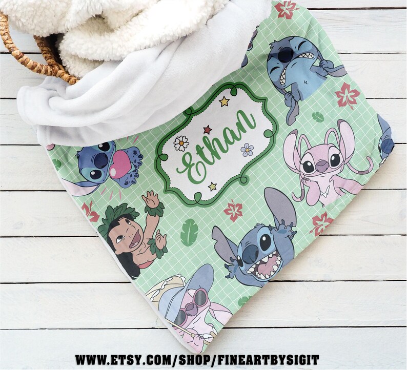 May include: A personalized baby blanket featuring cartoon characters on a light green background. The blanket has a white sherpa backing and a design with the name "Ethan" in a decorative frame. The blanket is decorated with cartoon characters.
