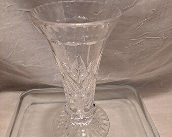 May include: A clear glass vase with a cut crystal design. The vase has a wide mouth and a narrow base.