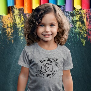 Kids T-Shirt Lifestyle Mockup Athletic Heather Bella+Canvas 3001T Girl Toddler Model in Crewneck Jersey Back-To-School Chalkboard Backdrop