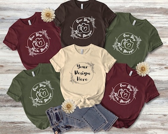 May include: Five different t-shirts with various colors and designs. The shirts feature a camera graphic with the text "One Step Mock Shoppe". One shirt has the text "Your Design Here".