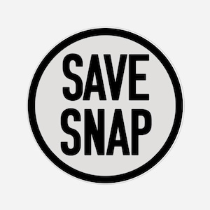 May include: A round sticker with the words "SAVE SNAP" in bold, black capital letters. The text is centered on a light gray background, encircled by a thick black ring.