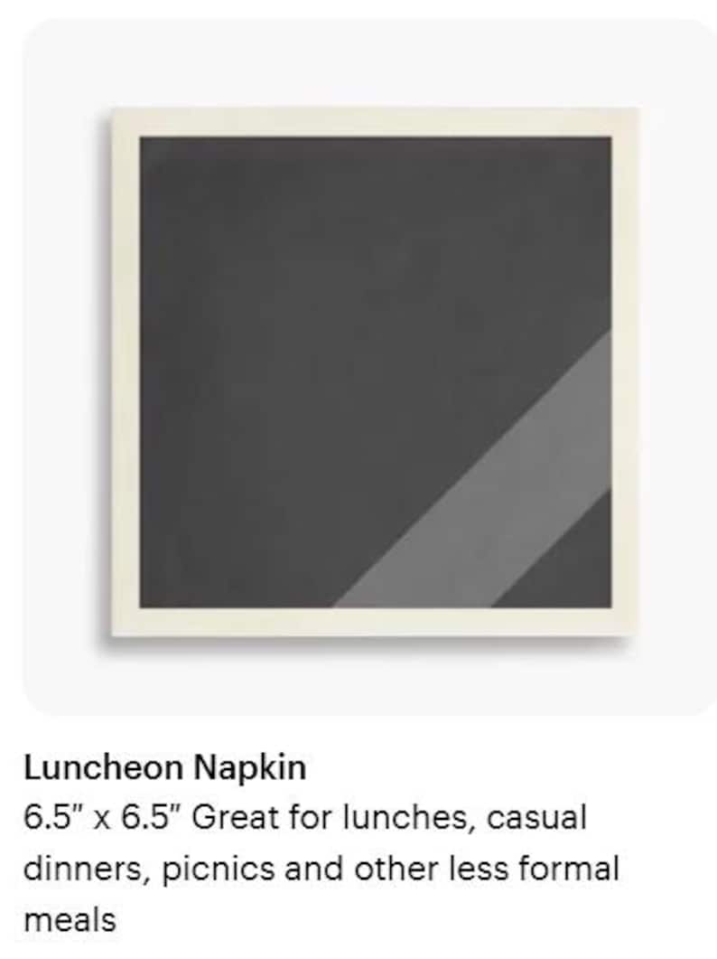 May include: Square luncheon napkin, 6.5 x 6.5 inches, with a dark gray center and a light gray diagonal stripe. The napkin has a cream-colored border, suitable for casual dining and picnics.