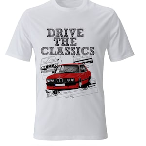 May include: White t-shirt with a red, white, and black graphic of three BMW cars. The text "DRIVE THE CLASSICS" is printed in black above the cars.