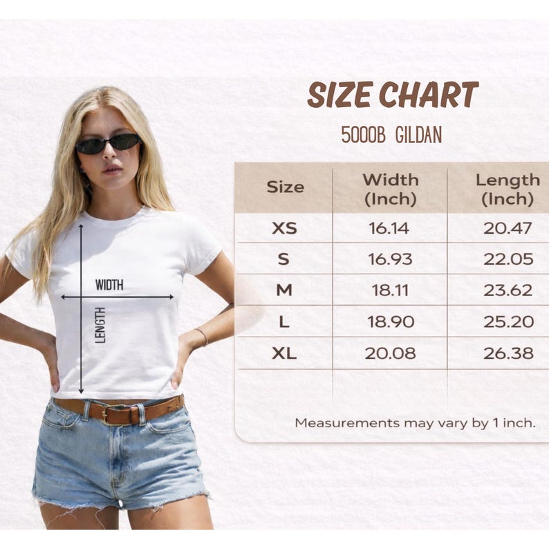 A woman wearing a white t-shirt and denim shorts, standing in front of a size chart for a 500DB GILDA t-shirt.