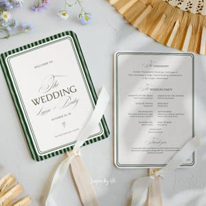 May include: Two rectangular wedding programme fans with dark green striped borders and white ribbons. The left fan reads Welcome to the Wedding of Laura and Bailey, October 20, 2X. The right fan lists the ceremony order, wedding party, and thank you.