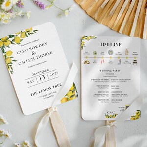 May include: Wedding fan programs with lemon and greenery design. The programs include the names Cleo Rowden & Callum Thorne, date December 13, 2025, and wedding details. The programs are tied with a ribbon.