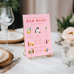 May include: A pink bar menu with the text "BAR MENU" and "Signature drinks". The menu features illustrations of cocktails, beer, wine, and spirits. The menu is displayed on a gold metal stand.