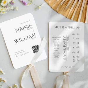 May include: White wedding fan with a black and white timeline of the wedding day. The fan includes the names Maisie and William and the text "Bridal Party Timeline".