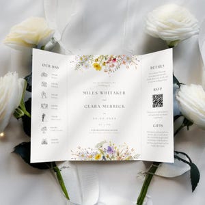 May include: A folded wedding invitation with a floral design. The invitation includes the names "Miles Whitaker" and "Clara Merrick", and the date and time. The design features a schedule, RSVP information, and gift details.