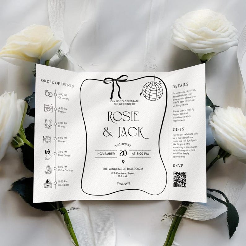 May include: A folded wedding invitation with the names "Rosie & Jack" in elegant script. The invitation includes event details, a timeline, and RSVP information. White roses and ribbons frame the invitation.