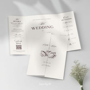 May include: A wedding invitation suite with a trifold design. The invitation features the words "The Wedding" and details, with a swan illustration and the names "Emily & Liam". Includes RSVP information.
