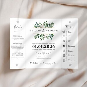 Puede incluir: Una invitación de boda con un diseño floral verde y dorado. La invitación incluye los nombres Phillip y Georgia, la fecha de la boda 01.01.2026 y la ubicación St. Andrews Church, Londres. La invitación también incluye una línea de tiempo de los eventos del día de la boda.