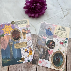 May include: Two decorative journal cards with fairytale themes. One features Rapunzel imagery, the other Sleeping Beauty. Both cards have collage elements, including illustrations, text, and decorative frames. A purple flower sits above the cards.