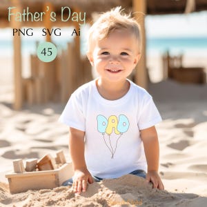 May include: A young child wearing a white t-shirt with the word "DAD" written on balloons. The image includes the text "Father's Day" and other file type indicators. The child is sitting on the sand at the beach.
