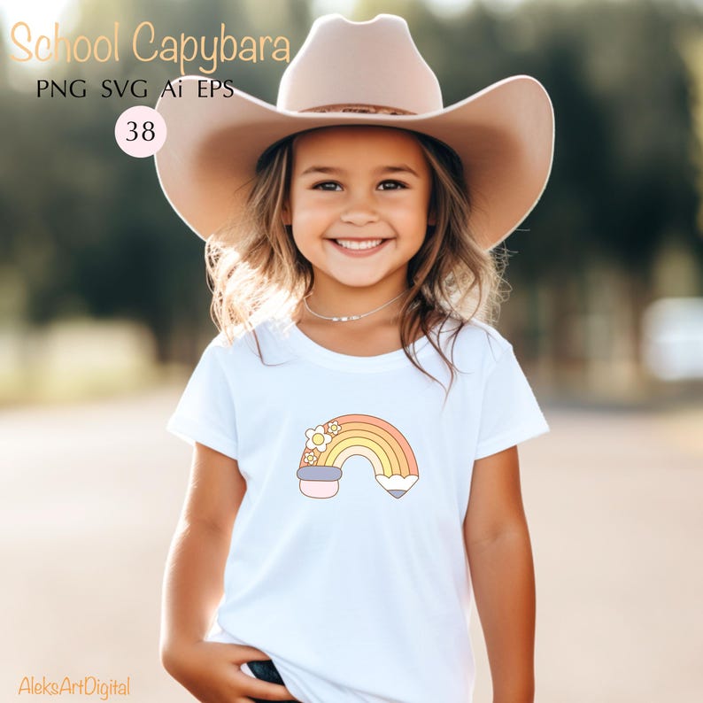 May include: White t-shirt featuring a colorful rainbow design with flowers and a pencil. The shirt has the text "School Capybara" and "PNG SVG AI EPS" in the upper left corner. The number "38" is in a circle. The shirt is worn by a smiling child.