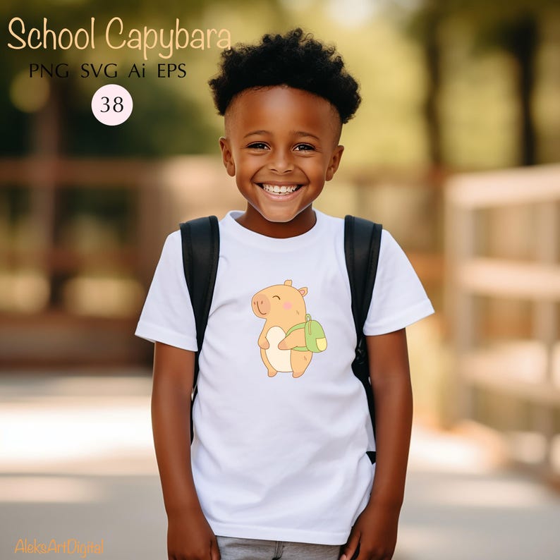 May include: White t-shirt featuring a cartoon capybara with a green backpack. The shirt has the text "School Capybara" at the top. The image also includes the numbers "38" in a circle. The shirt is worn by a smiling child.