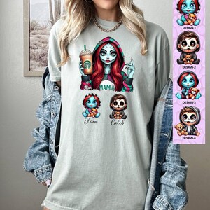 May include: A light green t-shirt with a graphic of a female character with red hair and a green and pink outfit holding a coffee cup. The character is labeled "Mama". Below the character are two smaller characters, one labeled "Olivia" and the other labeled "Caleb".