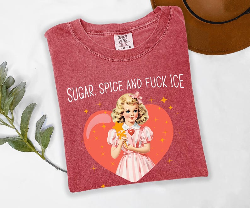 May include: Red Comfort Colors t-shirt with the text "SUGAR, SPICE AND FUCK ICE". The shirt features a vintage illustration of a girl inside a heart. The girl is wearing a pink dress and holding a star wand.