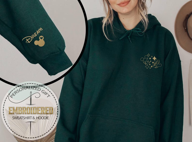 May include: Dark green hoodie with gold embroidered Mickey Mouse and text. The left sleeve features the word "Dream" and a Mickey Mouse head. The hoodie is a personalized gift, embroidered with the words "Sweatshirt & Hoodie".