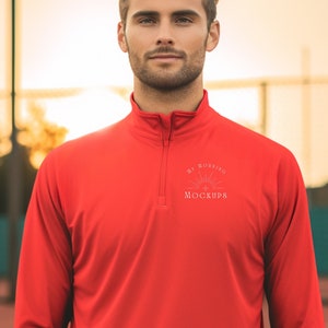 May include: A bright red long-sleeve shirt with a quarter-zip collar. The shirt features the text "MY ROSSINO MOCKUPS" in white on the chest. The shirt is made of a lightweight material, suitable for athletic wear.